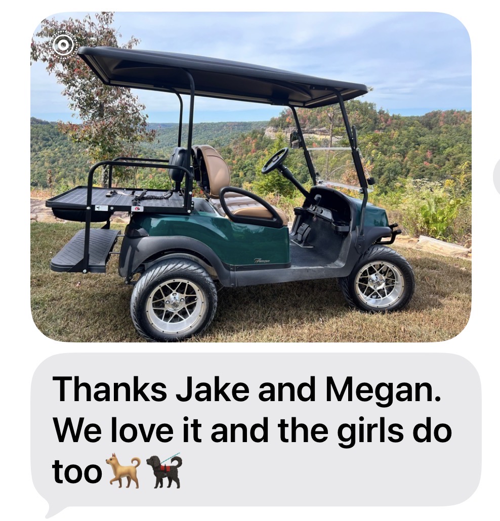 Customer’s green Club Car Tempo overlooking a wooded valley